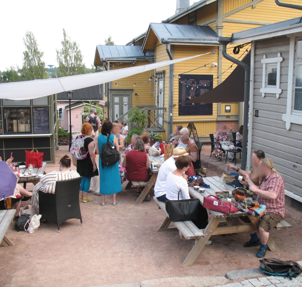 A view over the festival area. People knitting and chatting.