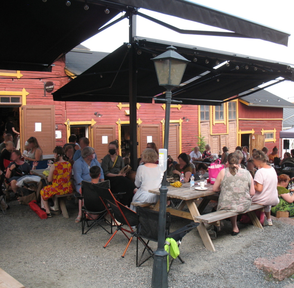 People sitting, knitting and talking at the festival